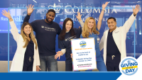 Students with Giving Day sign